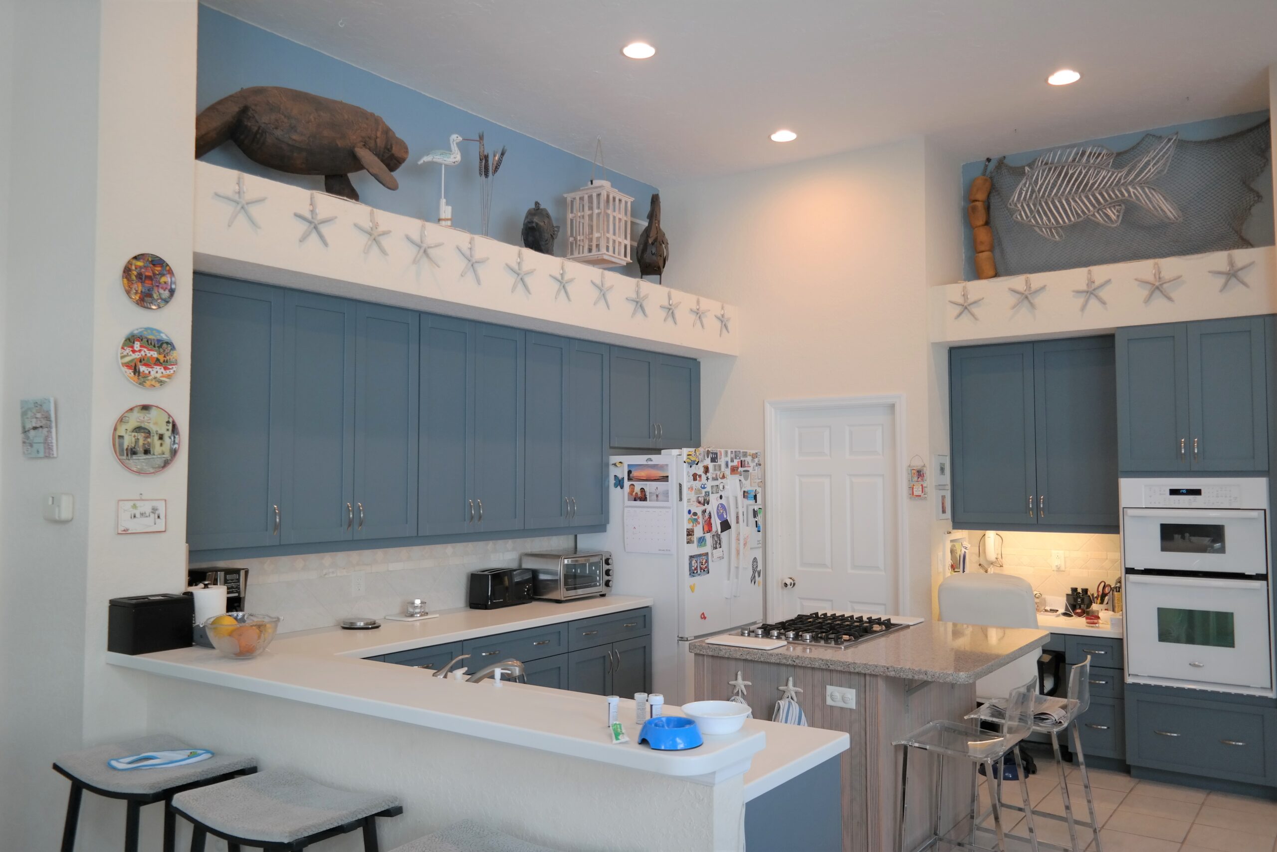 Classy High Quality Beach Style Home With Beach Blue Shaker Cabinet Doors in Land o Lakes.