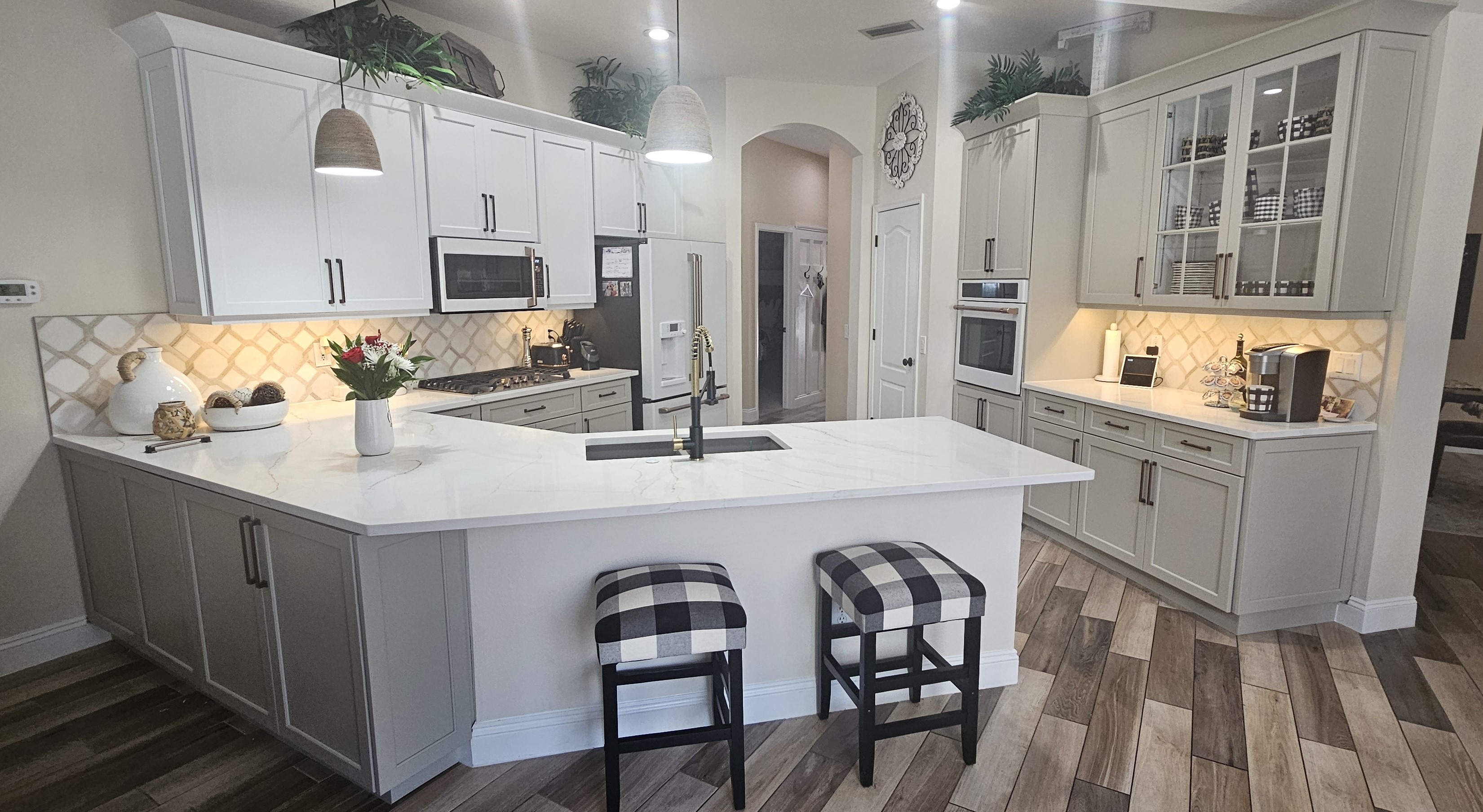 Modern appliances with a high-quality finish, granite worktops, and sleek white kitchen cabinets in Odessa.